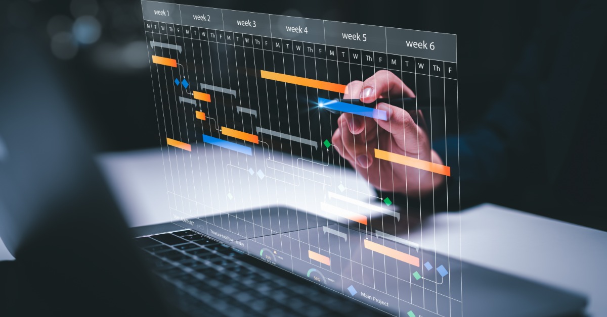 A digital project management chart shows colored bars across a six-week timeline. It floats above a laptop keyboard.